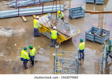 BELGRADE, SERBIA - NOVEMBER 18, 2020: Worker With Empty Builders Skip At Construction Site. Abstract: Rubble Removal.