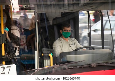 Belgrade, Serbia - October 02, 2020: Driver Wearing Face Surgical Mask Driving A City Bus With Passengers, From Outside Through Front Glass