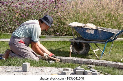 Belgrade, Serbia - October 09, 2020: Builder Worker Arranging The Granite Cobblestone Sett , Paving Decorative Pedestrian Pathway In The Garden Park In Karadjordjeva Street