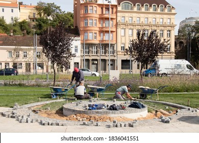 Belgrade, Serbia - October 09, 2020: Builder Workers Arranging The Granite Cobblestone Sett , Paving Decorative Pedestrian Pathway And Pedestal In The Garden Park In Karadjordjeva Street