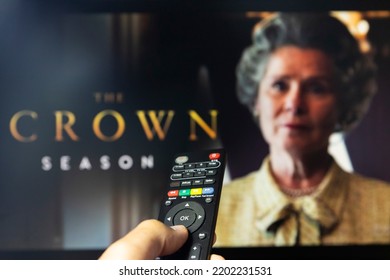 Belgrade, Serbia - September 12, 2022: Watching TV Show The Crown On Netflix With Remote Control In Hand.  TV Series Is About British Royal Family And Queen Elizabeth II.