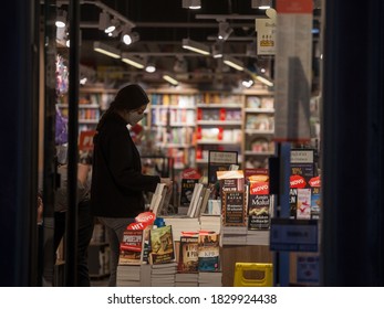 BELGRADE, SERBIA - SEPTEMBER 28, 2020: Female Client, A Girl, Choosing A Book In A Bookstore Wearing A Respiratory Face Mask In Belgrade, During The Coronavirus Covid 19 Health Crisis.

