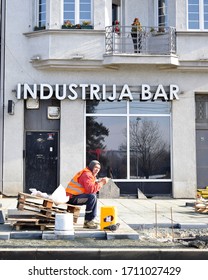 Belgrade/Serbia- May 11, 2019: A Construction Worker Seating On A Stool During A Brake From Putting Decorative Concrete Panels On The Pedestrian Walk.