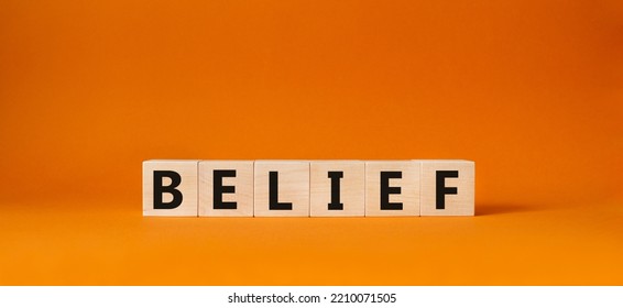 Belief Symbol. Concept Word Belief On Wooden Cubes. Beautiful Orange Background. Business And Belief Concept. Copy Space.