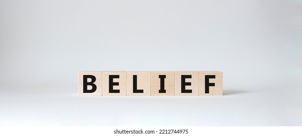 Belief Symbol. Concept Word Belief On Wooden Cubes. Beautiful White Background. Business And Belief Concept. Copy Space.