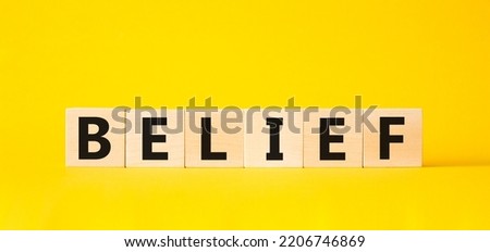 Belief symbol. Concept word Belief on wooden cubes. Beautiful yellow background. Business and Belief concept. Copy space.