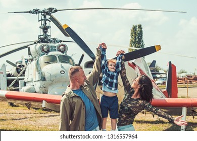 I Believe I Can Fly. Family Couple With Son On Vacation Travel. Woman And Man With Boy Child At Helicopter. Air Tour And Travel. Enjoying Travelling By Air. Happy Family Vacation.