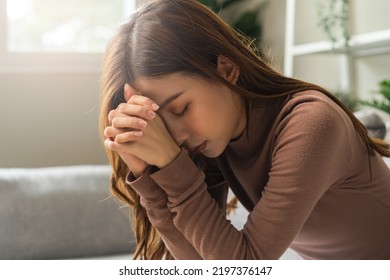 Believe faith charity, calm asian young woman show gratitude, folded hands in prayer feel grateful, meditating with her eyes closed, praying to request God for help. Religious, forgiveness concept.
