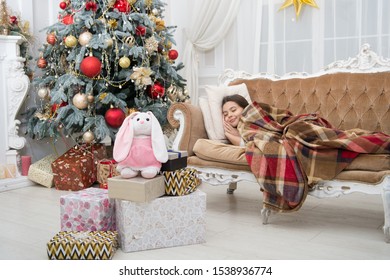 Believe In Miracles. Magical Moment. Christmas Night. Happy New Year. Family Holiday. Christmas Tree And Presents. Dreaming About Gifts. Little Girl Sleep Couch Near Christmas Tree Classic Interior.