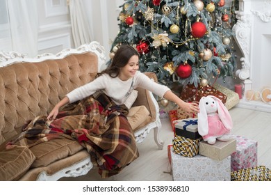 Believe In Miracles. Magical Moment. Christmas Morning. Happy New Year. Little Girl Sleep Couch Near Christmas Tree Classic Interior. Christmas Tree And Presents. Dreaming About Gifts. Family Holiday.