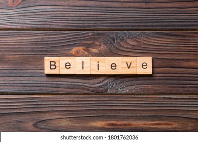 Believe Word Written On Wood Block. Believe Text On Table, Concept.