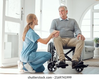 I Believe You Can Recover From This. Shot Of A Young Nurse Caring For An Older Man In A Wheelchair.