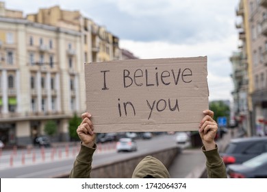 Believe In You. Support Phrase For Body Positive Movement. Self-respect And Self Love Support.  Hands Holding Banner Outside On City Streets. Social Care Motivation Concept. Friendly Mood Attitude.