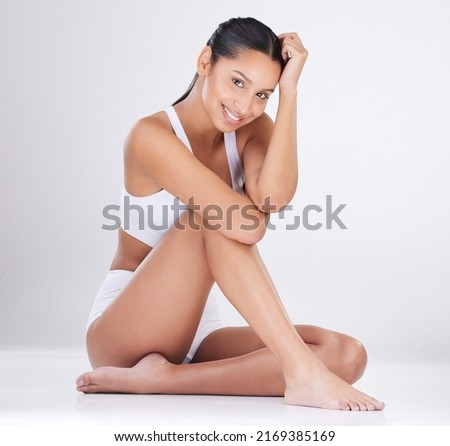 Believe in your own beauty. Studio portrait of an attractive young woman posing in her underwear against a grey background.