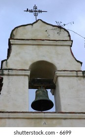 bell hanging high in church structure