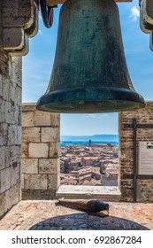 A bell on the top of the La Torre del Mangia, Piazza del Campo, Palazzo Pubblico. Siena, Italy.