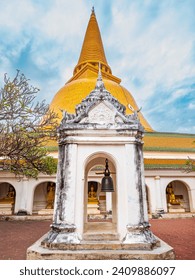 A bell pavilion in the front Gigantic Pagoda in a blur view of Buddha statues inside the corridor of the Buddhist temple