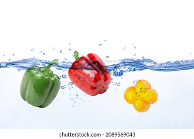 Bell pepper (green, yellow and red bellpepper) in water splash isolated on white background. Copy space.
