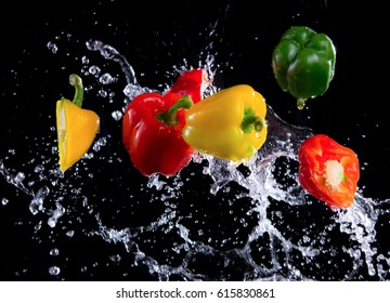 Bell peppers peppers with splash isolated on black background, motion action. - Powered by Shutterstock