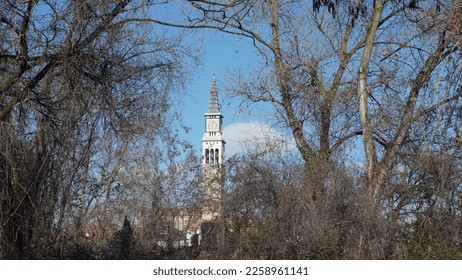Bell tower of the church of Ponte San Pietro, seen from the countryside. Bergamo province. Winter season - Shutterstock ID 2258961141