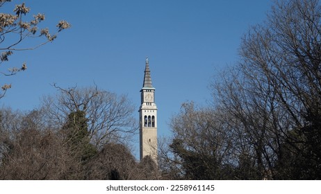 Bell tower of the church of Ponte San Pietro, seen from the countryside. Bergamo province. Winter season - Shutterstock ID 2258961145