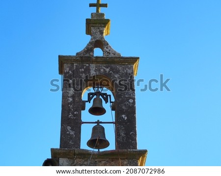 Bell tower of the church of Santa Eufemia do Monte, gray stone, two bells, finished with a cross, La Coruña, Spain, Europe