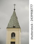 The bell tower of the Church of St. James the Apostle in Medjugorje during a cloudy day in Bosnia Herzegovina.