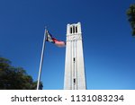 The bell tower and North Carolina state flag on the campus of NC State University 