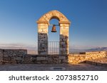Bell tower in Palamidi fortress on a hill above vast valley surrounded by mountains, Nafplio, Greece