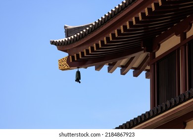 A bell to ward off evil hanging under the eaves of a temple