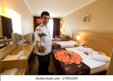 Bellboy With Flower At Hotel Room