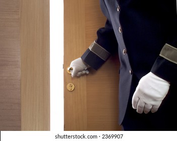 Bellboy Opening A Door In A Hotel