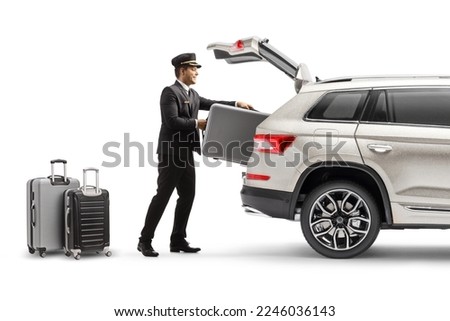 Bellboy putting suitcase in the trunk of a SUV isolated on white background