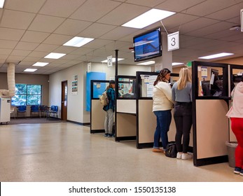 Bellevue, WA USA - November 1st, 2019: People Renewing License ID At Counter At The DMV In Bellevue, WA.