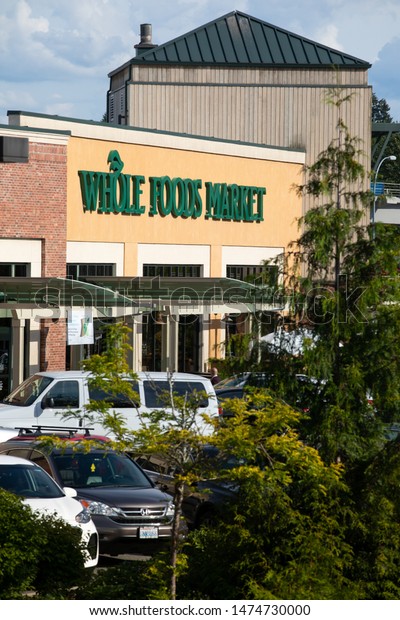 Bellevue, Washington / USA - July 16 2019:  Whole\
Food sign at the Amazon owned organic grocery store, with space for\
text on bottom