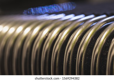 Bellow of an accordion or harmonica closeup pattern. Curved metal frames pattern.