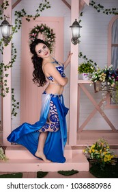 Belly dance. A girl is dancing east dance.Spring, many flowers. Blue suit. - Shutterstock ID 1036880986