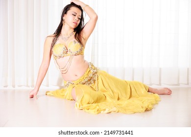 Belly dancer wearing a sitting yellow costume