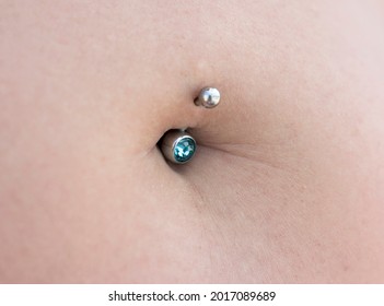 Belly ring piercing, belly button close up