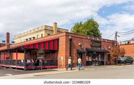 BELMONT, NC, USA-8 MARCH 2022: The Glenway Premium Pub, On Glenway St.  Two Men Approaching Entrance Door.