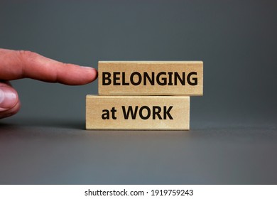 Belonging at work symbol. Wooden blocks with words 'Belonging at work' on beautiful grey background. Businessman hand. Business, belonging at work concept. Copy space. - Shutterstock ID 1919759243