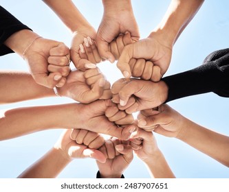 Below, hands and fist bump outdoor for teamwork, strength or unity for synergy. Group, huddle or people connected for power, solidarity or trust in community for protest, empowerment or organization - Powered by Shutterstock