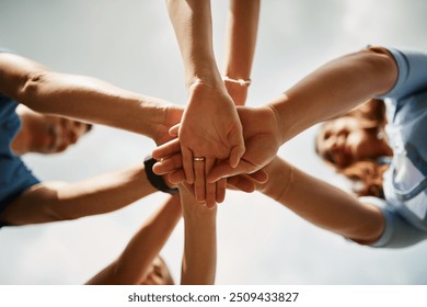 Below, hands and people in circle for support, synergy and trust in nature for growth. Team building, volunteers and outdoor with gesture for cleaning, cooperation and collaboration in environment