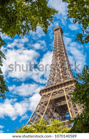 Similar – Eiffel Tower in green trees on blue sky