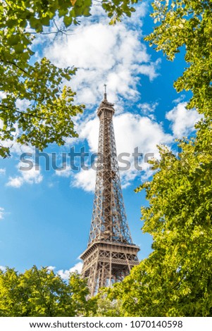 Similar – Eiffel Tower in green trees on blue sky