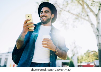 Below View Of Happy Male Tourist In Stylish Had Excited With Received Email With Online Travel Guide For Exploring City Area On Leisure, Positive Man Reading News On Website For Millennial Bloggers