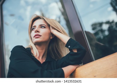 Below View Of Pondering Woman Dressed In Stylish Black Shirt Thougthful Looking Away And Thinking On Ideas, Attractive Hipster Girl In Casual Clothing Lost In Thoughts During Rest Time On City Bench