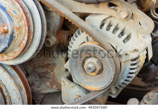 belt of the generator and an old car generator on\
the engine