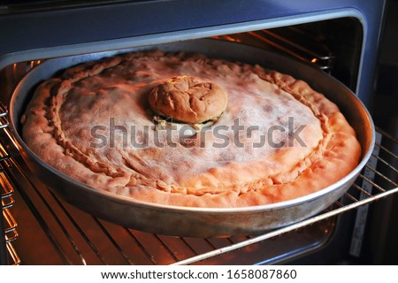 Belyash - a baked pie made from unleavened dough with various fillings. Tatar and Bashkir cuisine. Homemade meat and potato pie. Close-up. Background.