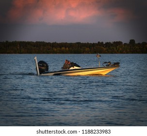 Bemidji, Minnesota - August 29, 2018: Sun Shines Through Clouds On Couple In Bass Fishing Boat On Lake Bemidji.